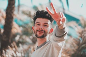 happy man showing peace gesture